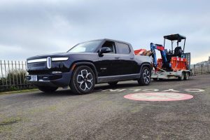 Rivian R1T towing electric mini digger